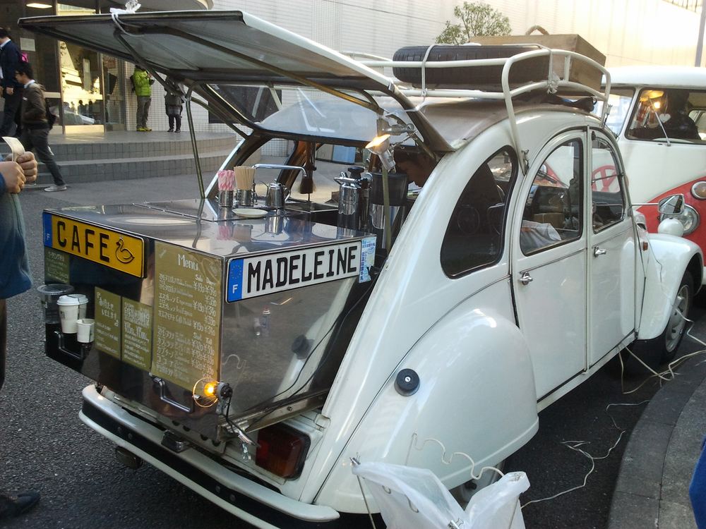 Carro antigo transformado em balcão de café num evento de rua